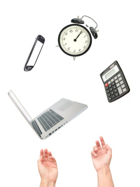 Multitasking concept. A pair of hands juggling a laptop, phone, clock, and calculator, representing the challenge of maintenance management.