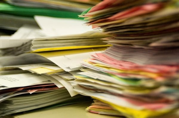 Stacks of paper work orders and other maintenance documents which could disappear by transitioning to a CMMS