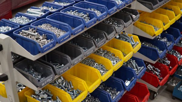 Storage bins for nuts, bolts, and screws in a stockroom to represent MRO tools and consumables.