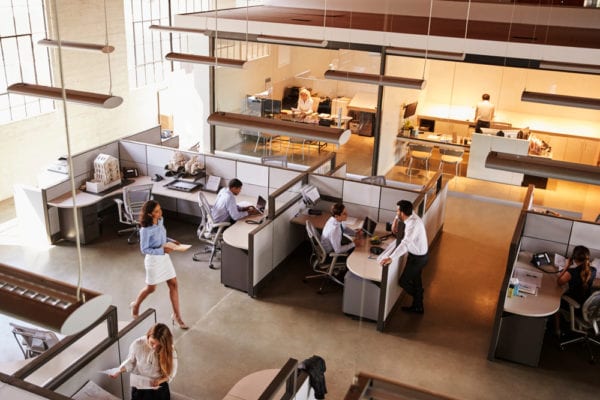 High angle view of a busy open office plan that benefits from proper facility management.