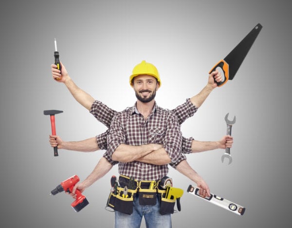 A worker with extra arms holding tools to symbolize maintenance technician shortage.