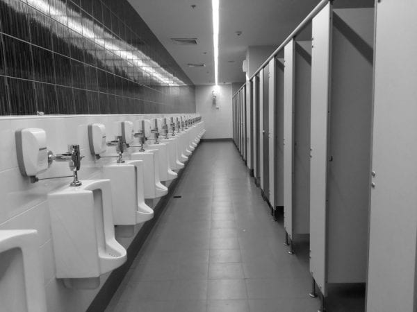 A restroom including fixture assets such as toilets, HVAC, and lighting.