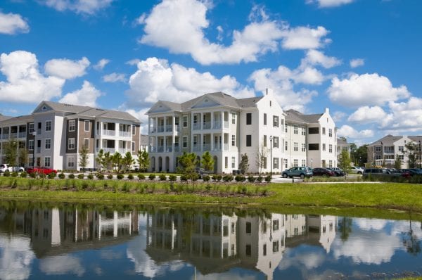 A property asset made up of apartment buildings on land that includes a pond.