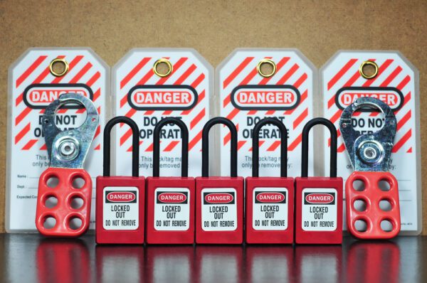 Padlock and hasp lockout devices and tagout device warning tags used for lockout/tagout procedures