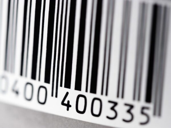 Close up view of a 1D barcode label, made up of parallel lines.