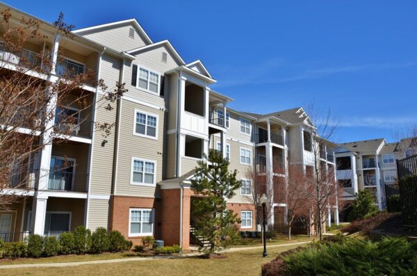 A well-maintained apartment complex on a sunny day illustrates what property management is.