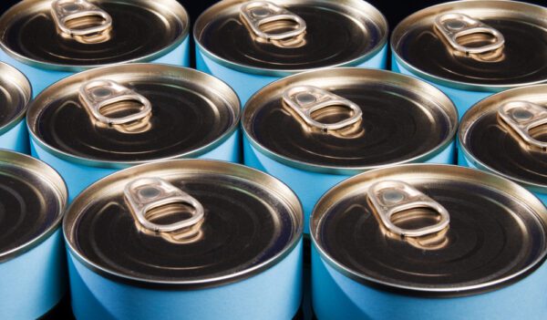 Close up of blue pop tab cans on a manufacturing line regulated by FDA Good Manufacturing Practices