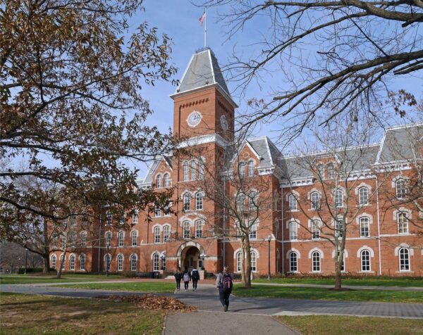 A large university campus in the fall with students walking inside, demonstrating maintenance challenges in the education industry