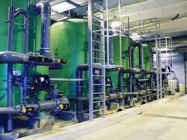 Row of industrial pumps in a building basement