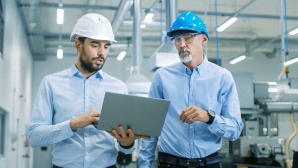 A maintenance manager advises a technician about how to enter information into a CMMS following implementation.