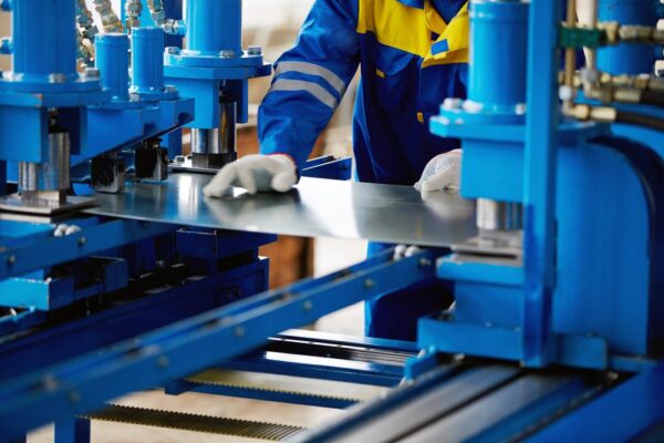 Maintenance technician using an asset that cuts sheet metal, one of the machines that will be included in Mean Time to Repair calculations.