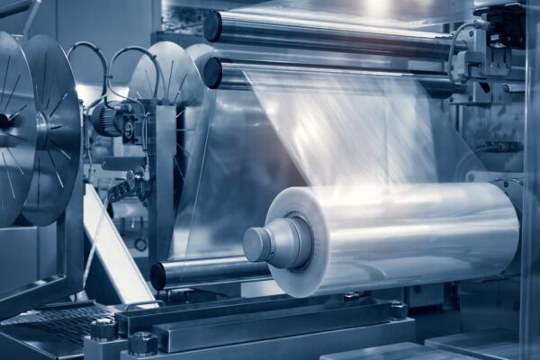 Close-up of plastic bag on roller of plastic sheeting production machine
