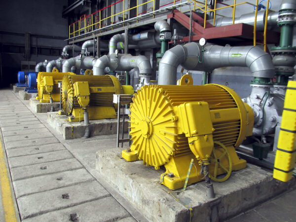 A row of identical water pumps with large electric motors that can be efficiently tracked with a proper asset naming convention