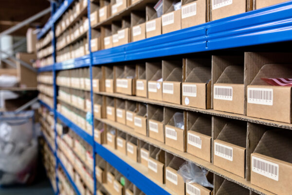 1D barcodes applied to shelving and storage bins in an inventory storeroom.