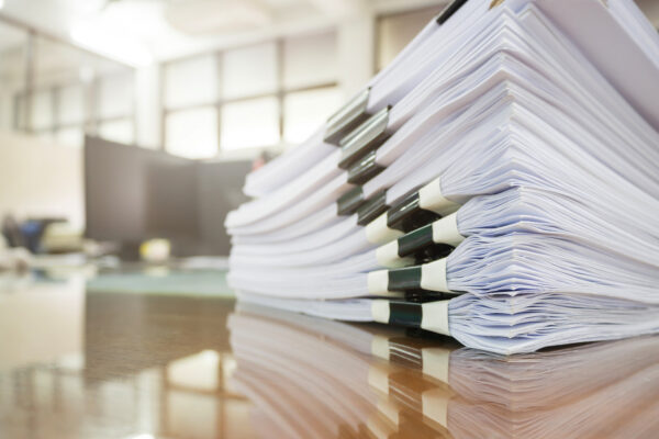 Close up of a stack of CMMS RFP vendor responses.
