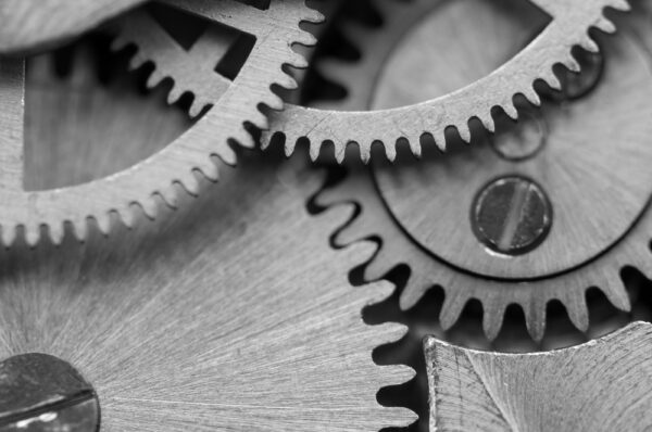 Close up of gears to represent implementation and parts working together.