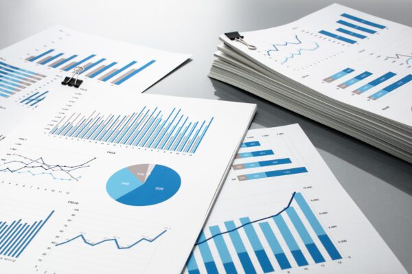 Stack of KPI maintenance reports showing charts and graphs of improvement.