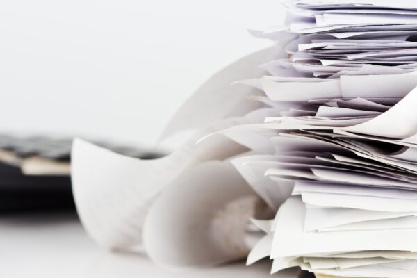 Unorganized stack of paperwork.