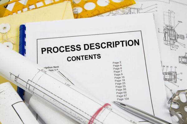 Close up shot of a process description manual documenting a maintenance procedure as part of an ISO 9001 quality management system.