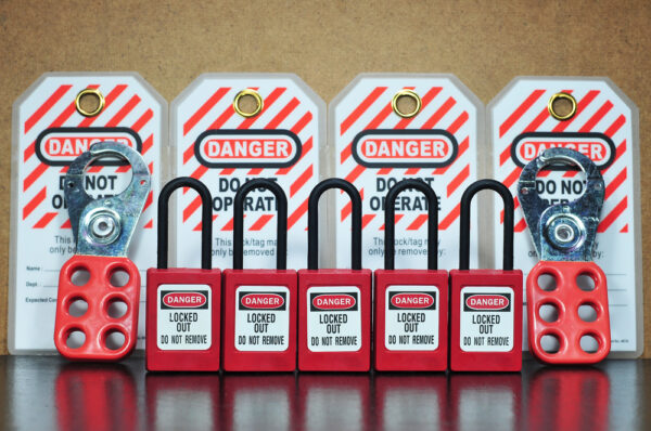 Close up of locks and tags for a lockout-tagout procedure required by workplace safety regulations.
