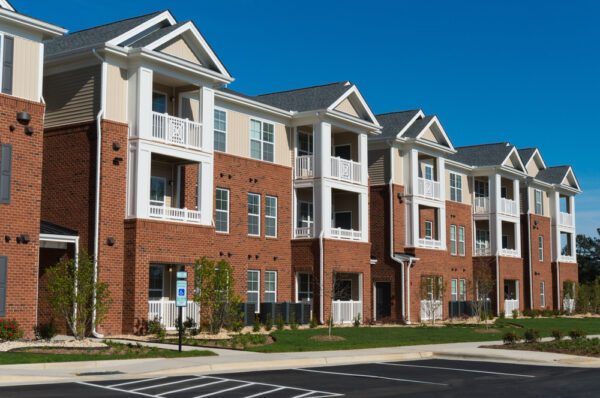 Modern apartment building in front of blacktop parking lot