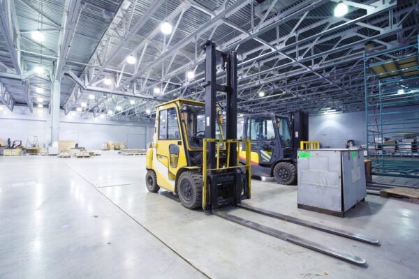 Forklift truck in a warehouse that is kept operational through time-based maintenance.